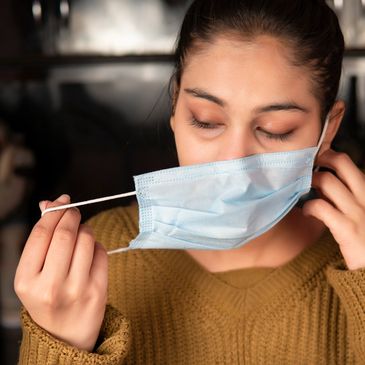 Tired long covid sufferer removes face mask