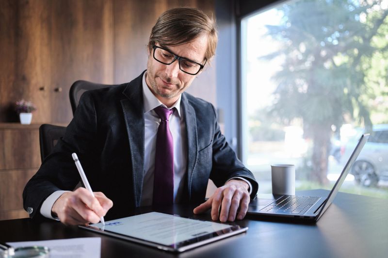 Man Signing The Digital Contract