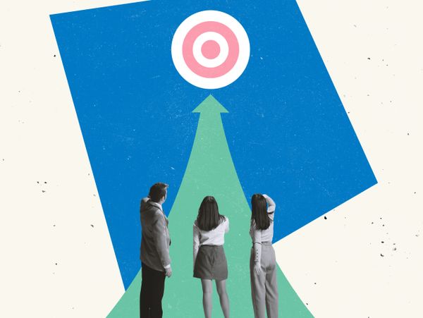 Three people looking at a target symbolizing goal-setting and focus.