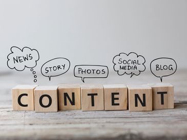 Wooden blocks spelling CONTENT with speech bubbles for news, story, photos, social media, and blog.