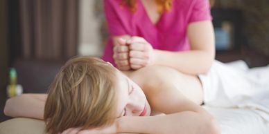 Child receiving a massage from a RMT