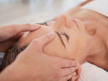 Person receiving a facial massage.