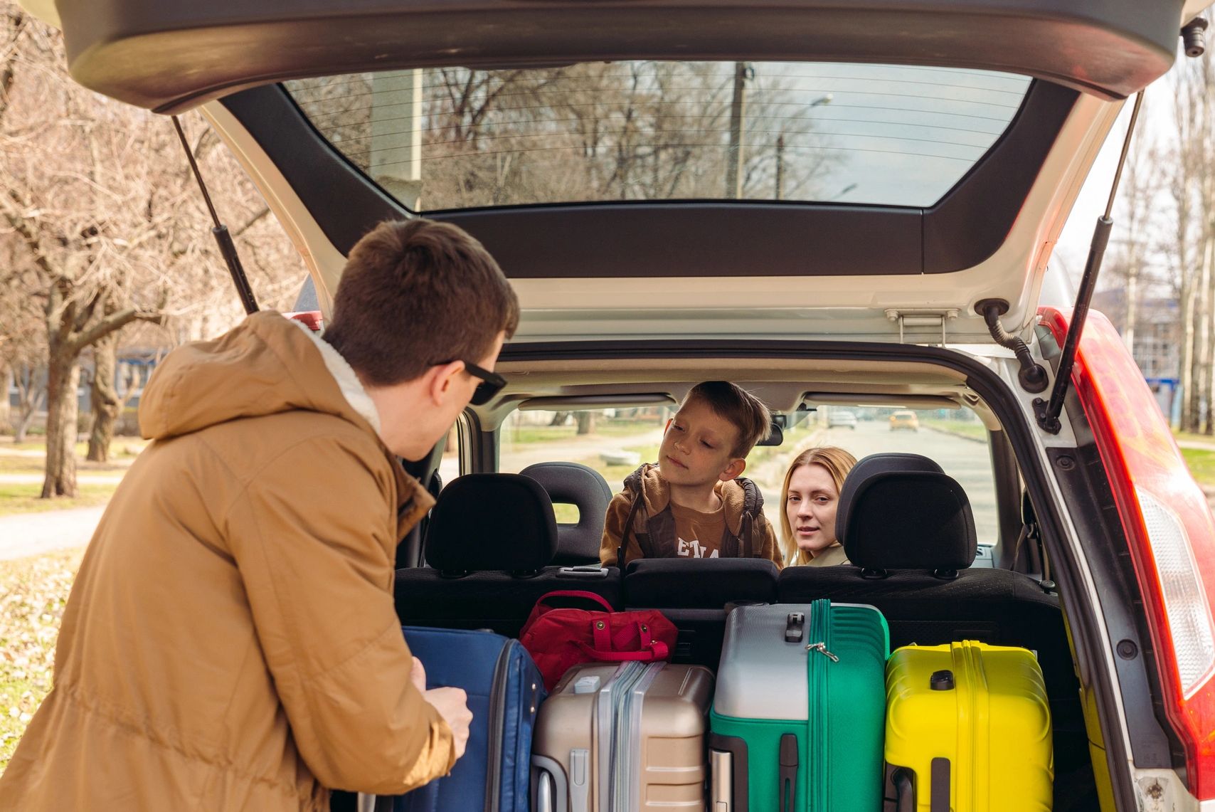 A happy family packing for a vacation while Brown Private Investigations protects their home.