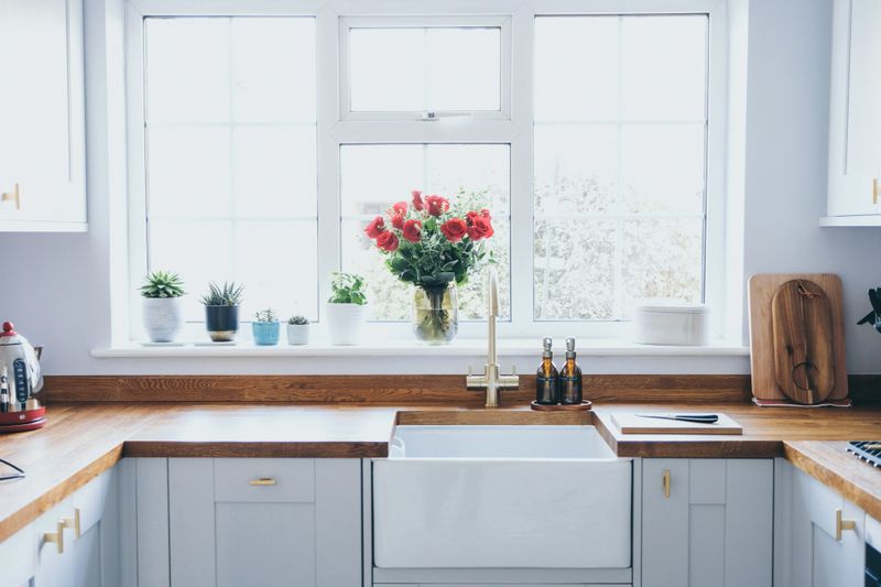 Modern and bright shaker style kitchen with wood worktop and Belfast sink