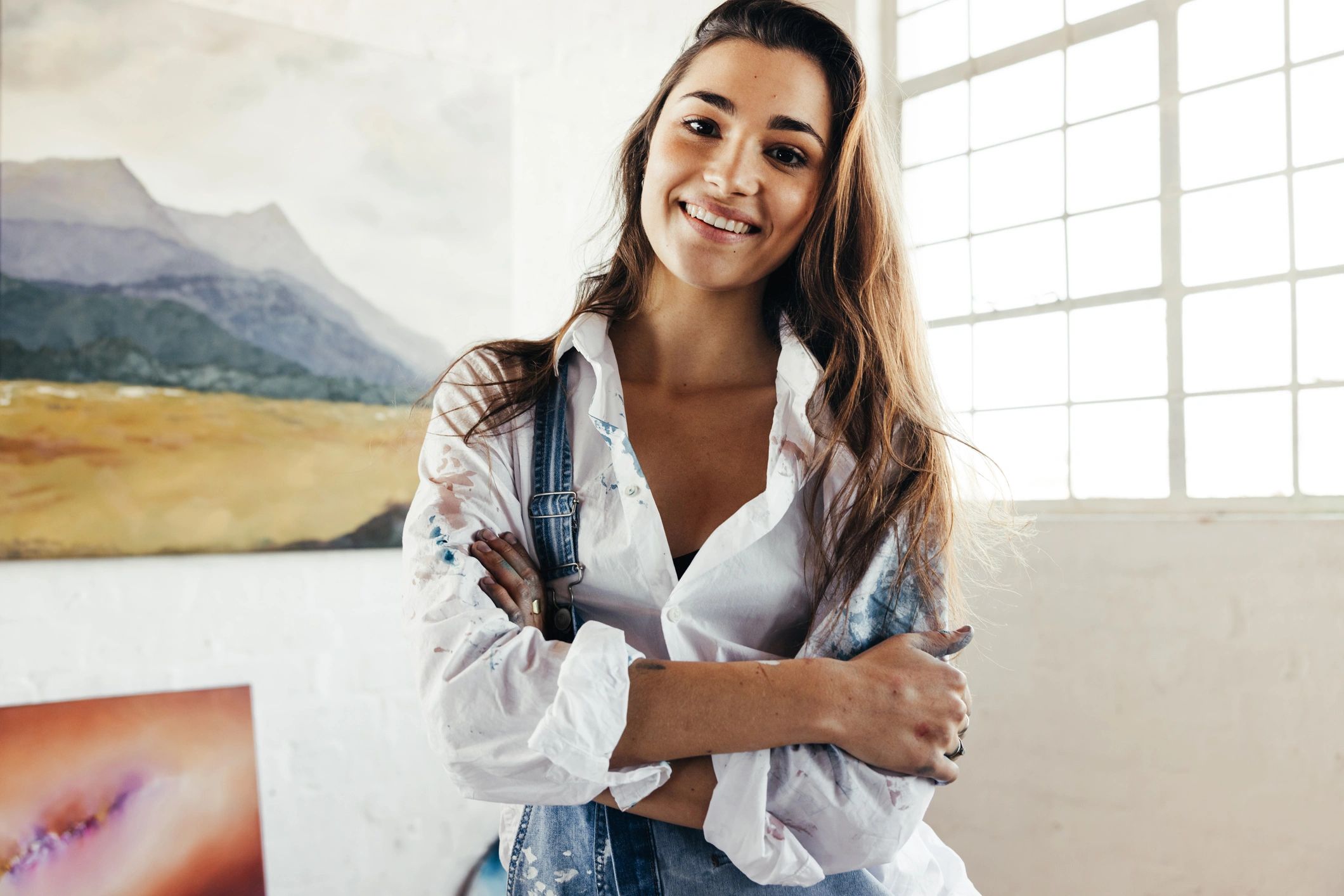 Young female in an art gallery smiling at camera