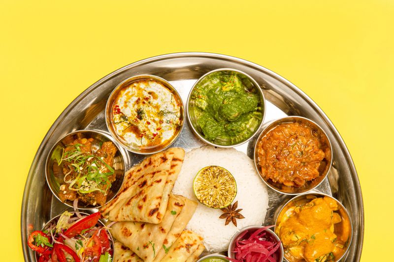 Typical south Indian Thali dishes served in a variety of traditional plates.