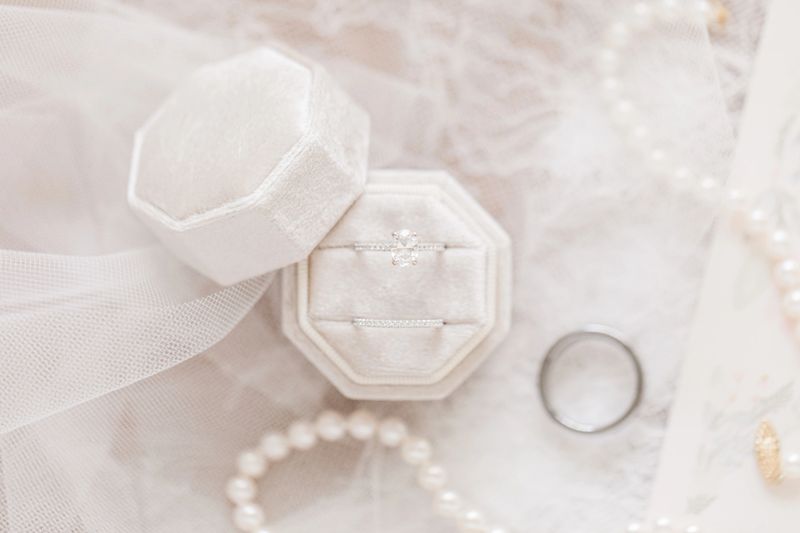White Gold Diamond Wedding Rings in a Velvet Ring Box in Bright Natural Light.