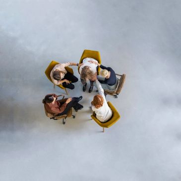 Group therapy session with supportive individuals comforting a person in distress.