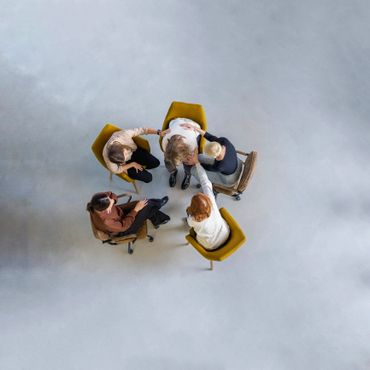 Group therapy session with supportive individuals comforting a person in distress.