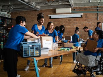 Volunteers organizing donations in a community center, fostering teamwork and inclusion.