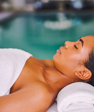 Woman receiving a relaxing head massage in our spa.
