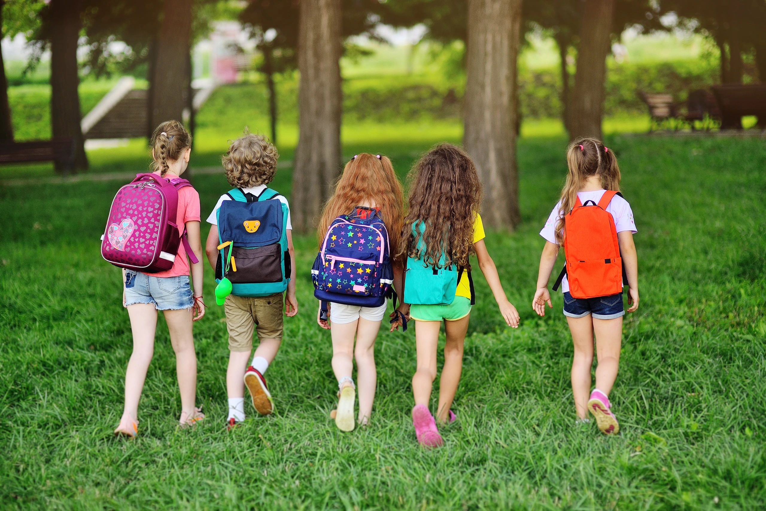 Children with backpacks for travel.