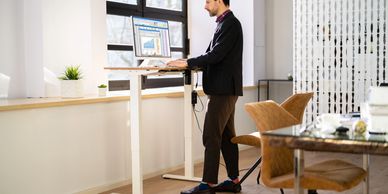 man at a sit to stand desk