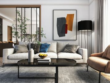 Modern living room with neutral tones and abstract art on the wall.