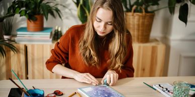 girl doing art at table — Admissions Excellence college consulting