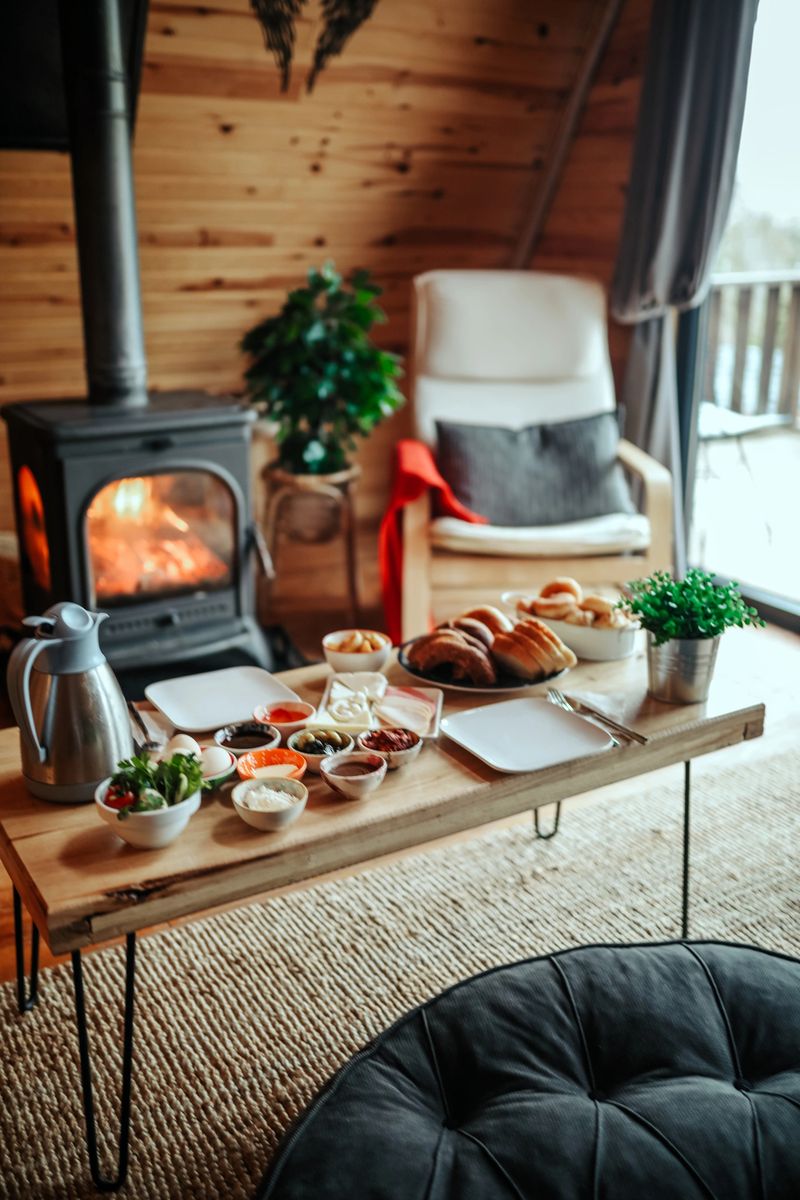 A breakfast table by the fireplace and a peaceful environment in the bungalow