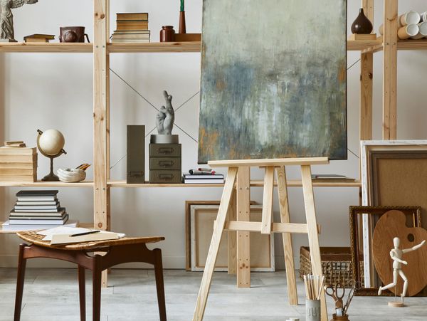Art studio with an abstract painting on an easel and various artistic tools.