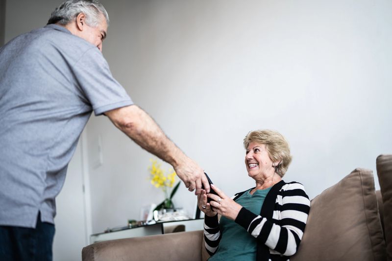 Woman receiving a smartphone from husband
