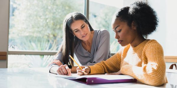 Teacher helping student with homework.