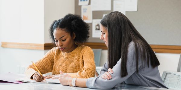 Student receiving tutoring in a classroom.