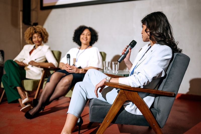 Group of female presenters having a discussion during presentation