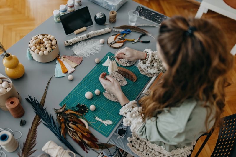 Young women making handmade jewelry at studio