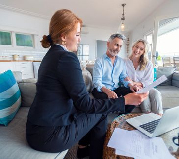 Couple meeting with a real estate agent indoors.