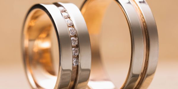 Two elegant gold rings, one with diamonds.