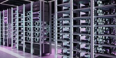 Rows of illuminated cryptocurrency mining rigs in a modern data center.
