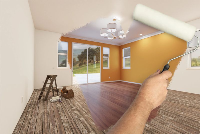 Before and After of Man Painting Roller to Reveal Newly Remodeled Room with Fresh Yellow Ochre Paint and New Floors.