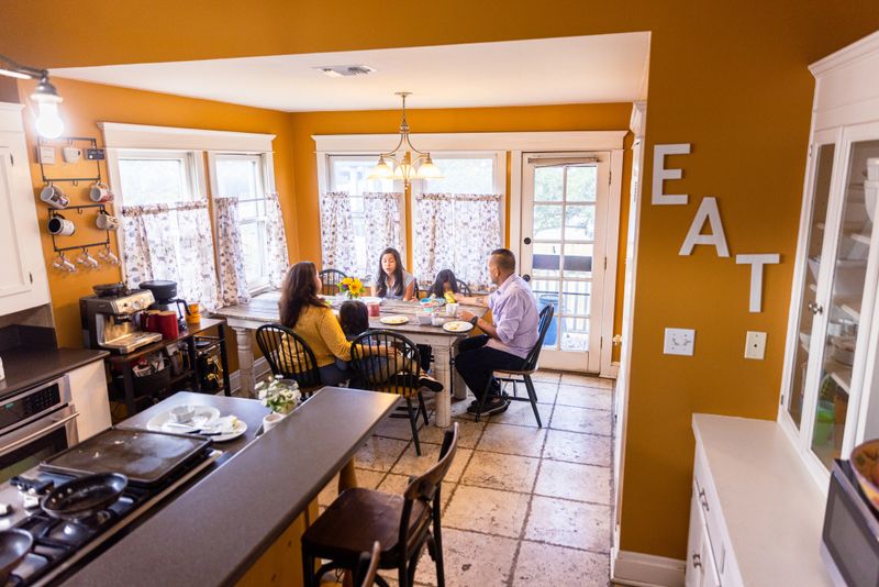 Young Mexican Family Having Breakfast together at home. One of the little boys has Down’s Syndrome.