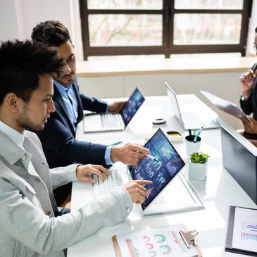 Colleagues collaborating on data analysis in a modern office.