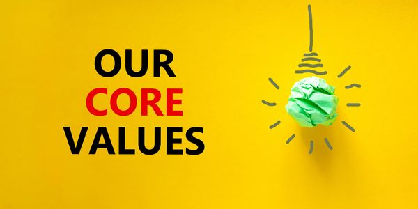 Our core values highlighted with a green crumpled paper light bulb.