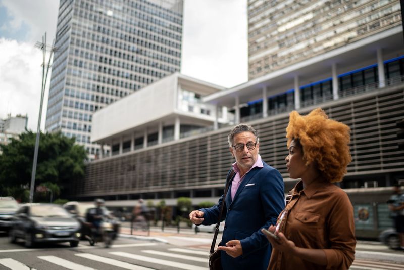 Coworkers talking and walking in the street