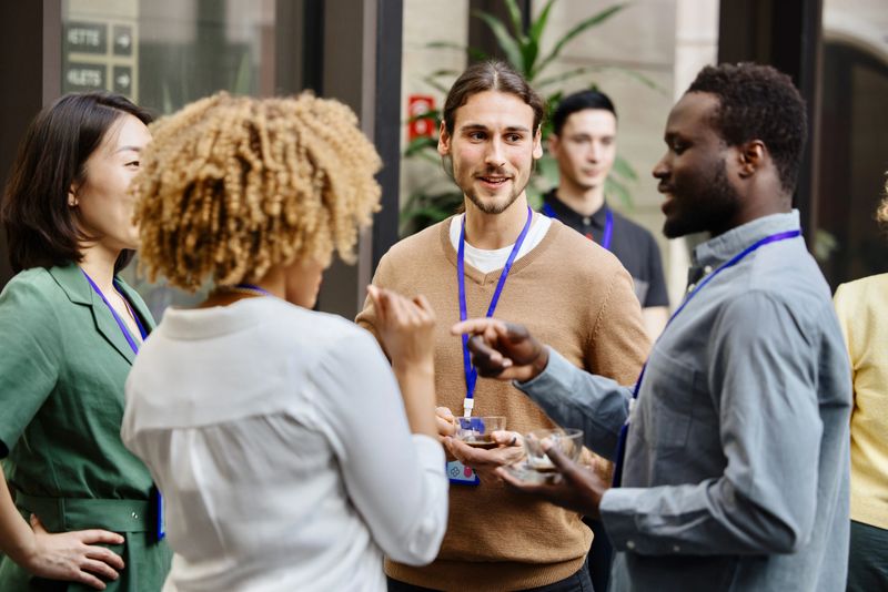 Group of people chatting during networking break at business conference