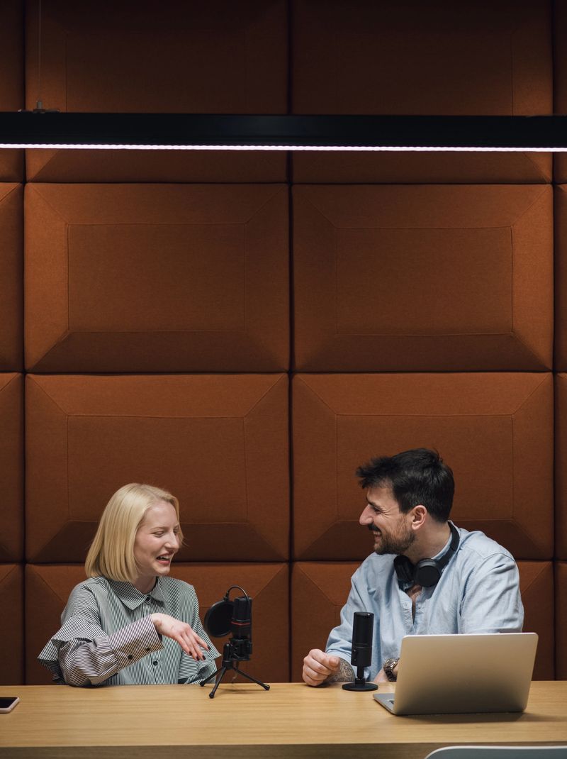 Two young hosts recording a podcast in a broadcast studio.