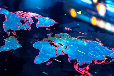 Digital world map with illuminated borders and data points.