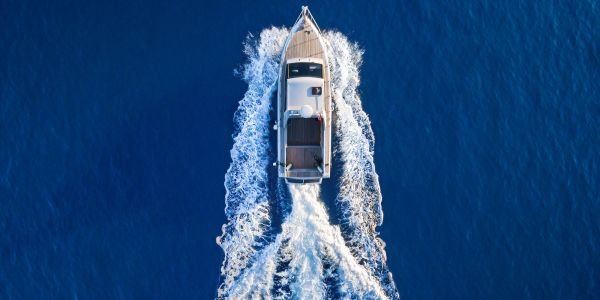 A motorboat moving fast on deep blue water.