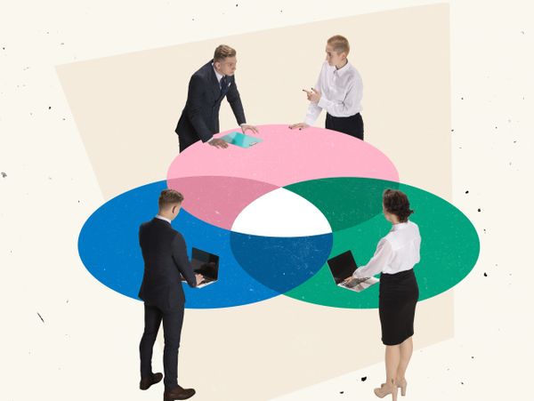 Four professionals collaborating over overlapping colorful circles representing teamwork.