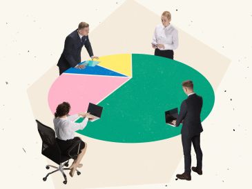 Four businesspeople discuss data shown on a large colorful pie chart.
