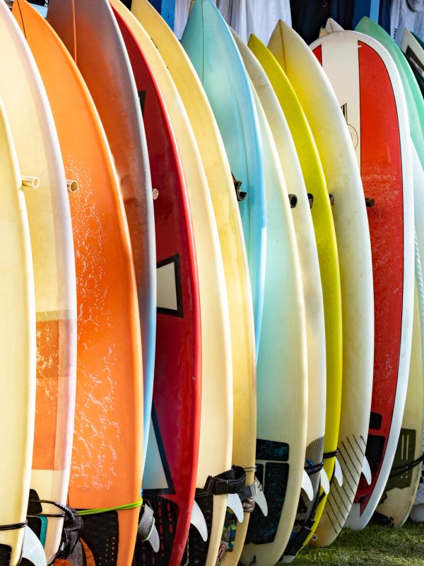 Colorful surfboards lined up vertically.