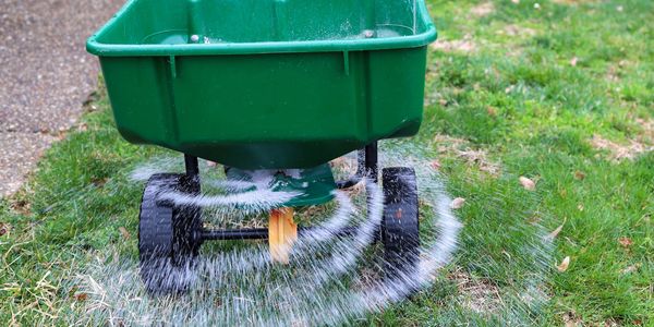 Fertilizer being spread on a lawn in Osceola.