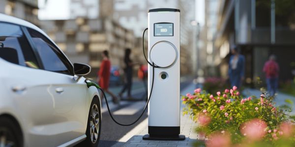 Electric car charging at a station in an urban area.