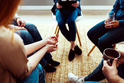 People sitting in a circle during a group CBT supervision session.