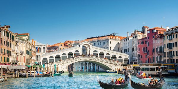 Rialto Bridge over Grand Canal with gondolas in Venice