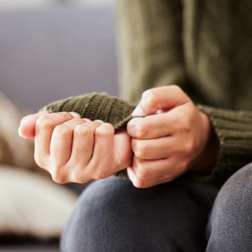 Person nervously wringing hands.