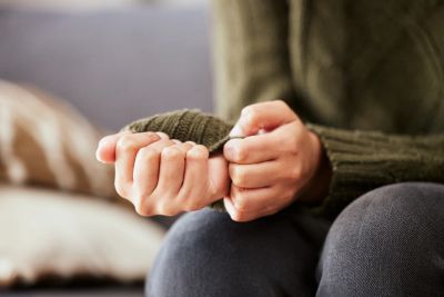 Person holding their wrist in discomfort.