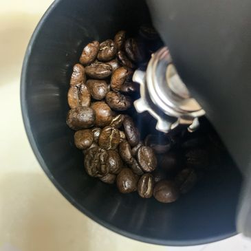 Close-up of coffee beans inside a grinder.