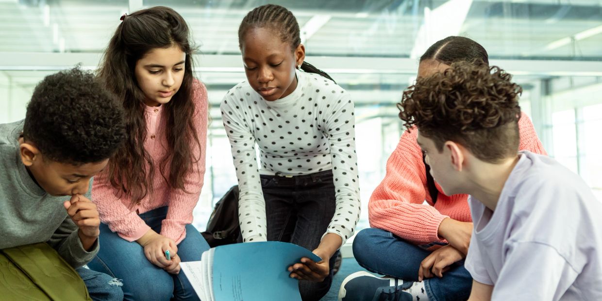 Group of diverse kids studying together.
