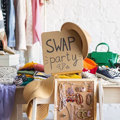 Sign and items for a swap party with clothes and accessories.